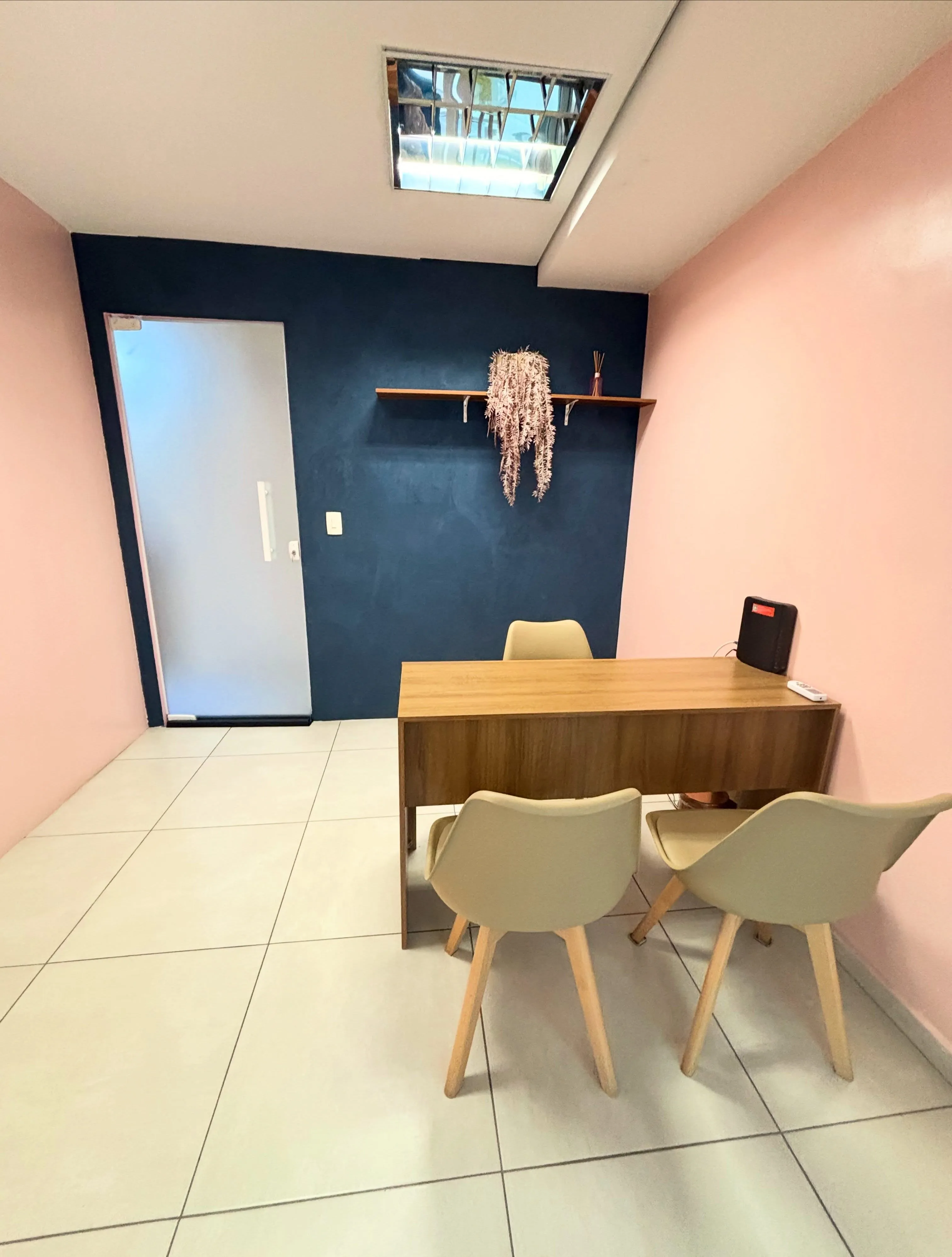 Sala Azul com mesa, três cadeiras e parede azul-marinho